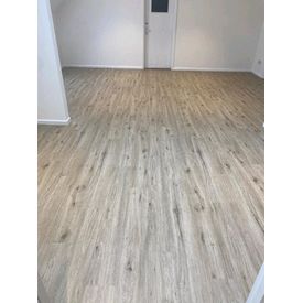 Elements luxury vinyl tiles in Cashew, light wood effect bedroom floor