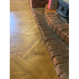 Flooring scribed into brick fireplace